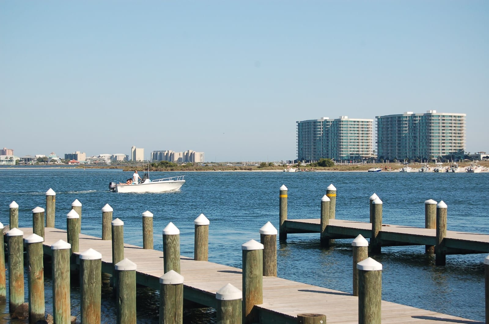 Archival photograph of a boat, docks and waterfront condominiums in Orange Beach, Alabama