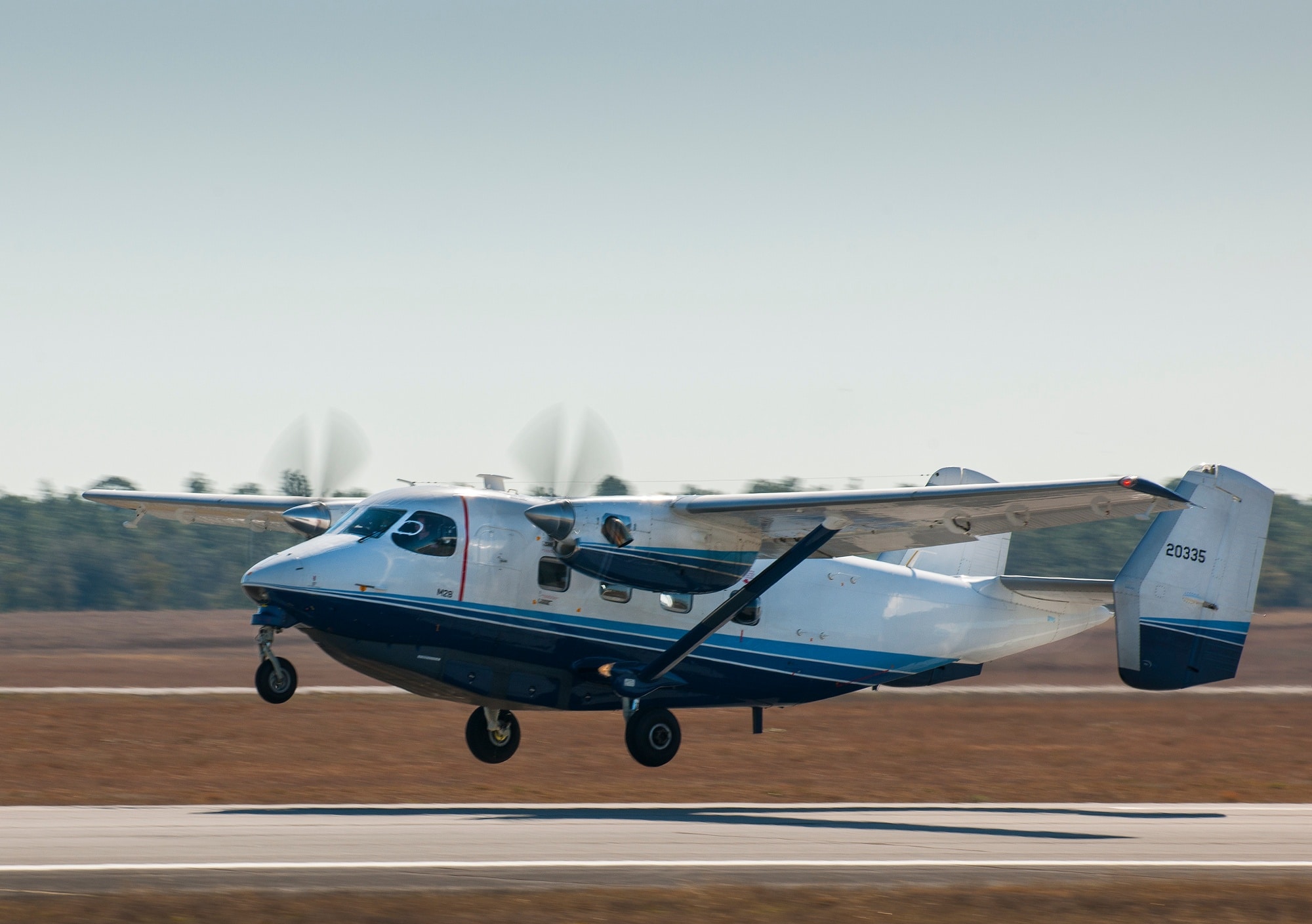 A C-145A Skytruck lifting off from the runway at Duke Field