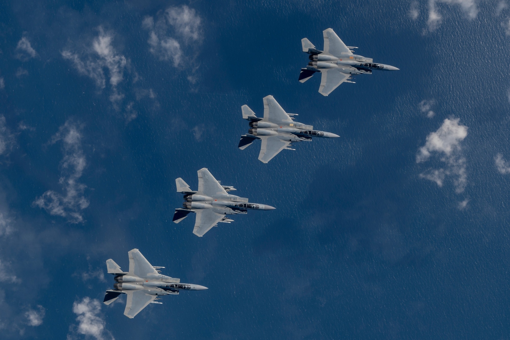 Four Eglin Air Force Base F-15EX Eagle II aircraft flying in formation over the Gulf