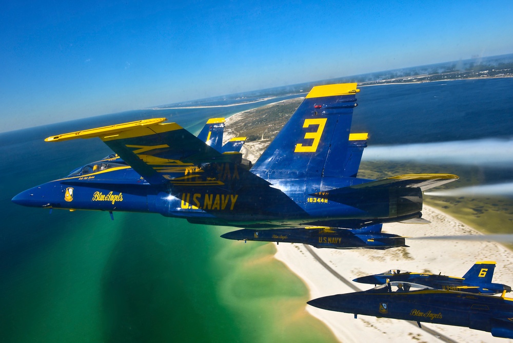 Blue Angels jets flying above Pensacola white-sand beaches and turquoise coastal water in 2013