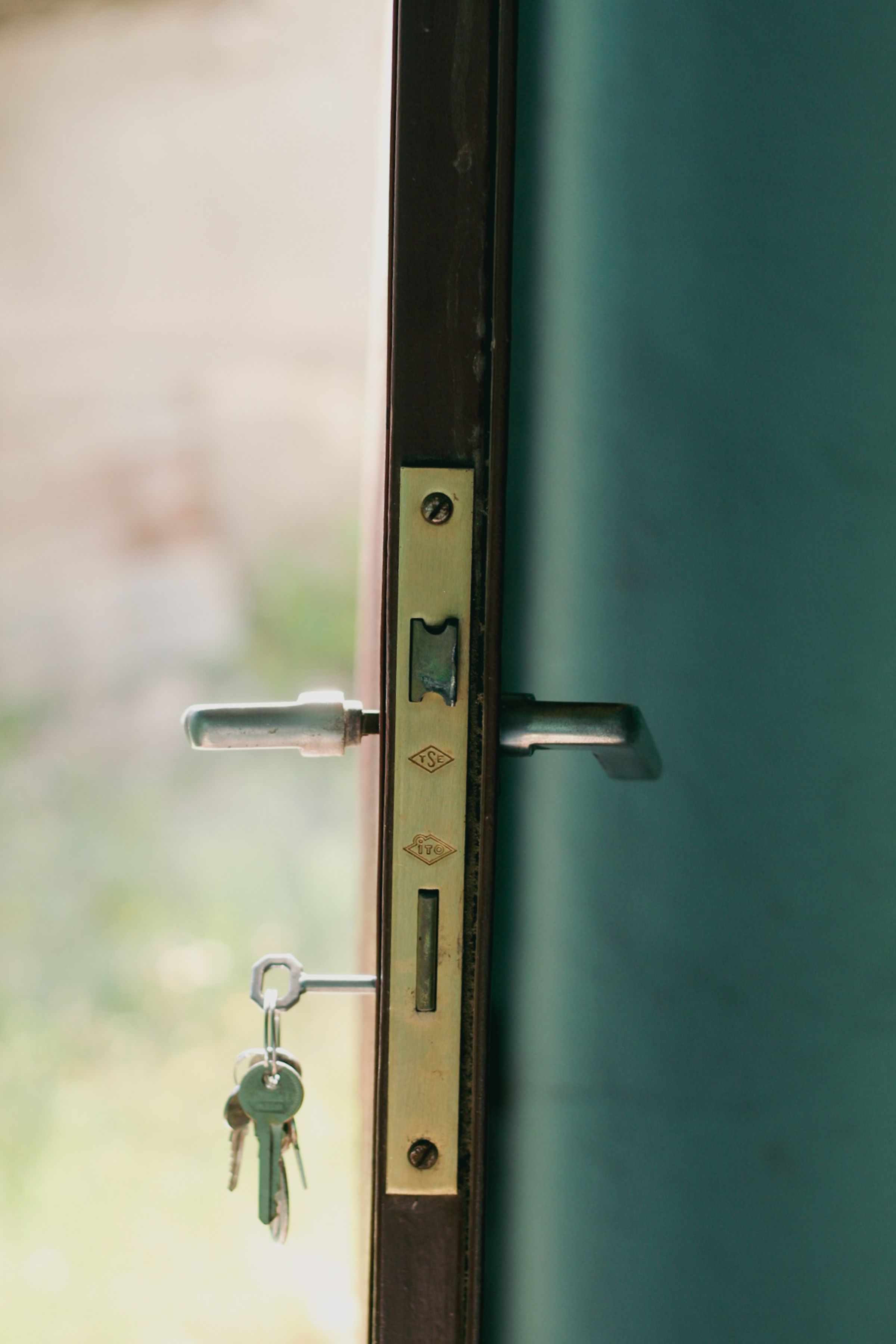 House keys hanging in the lock of an open front door